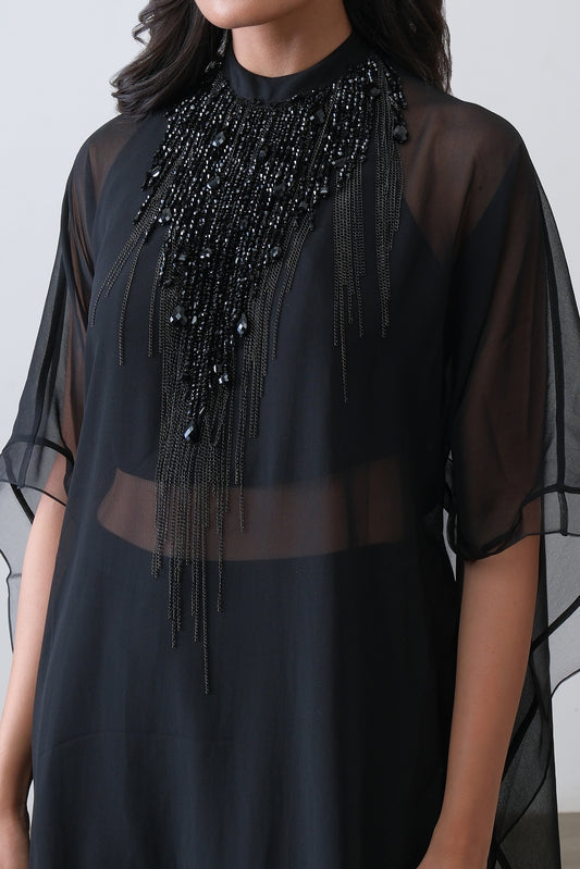 Close up of hand embroidered beaded neckline on black georgette cape