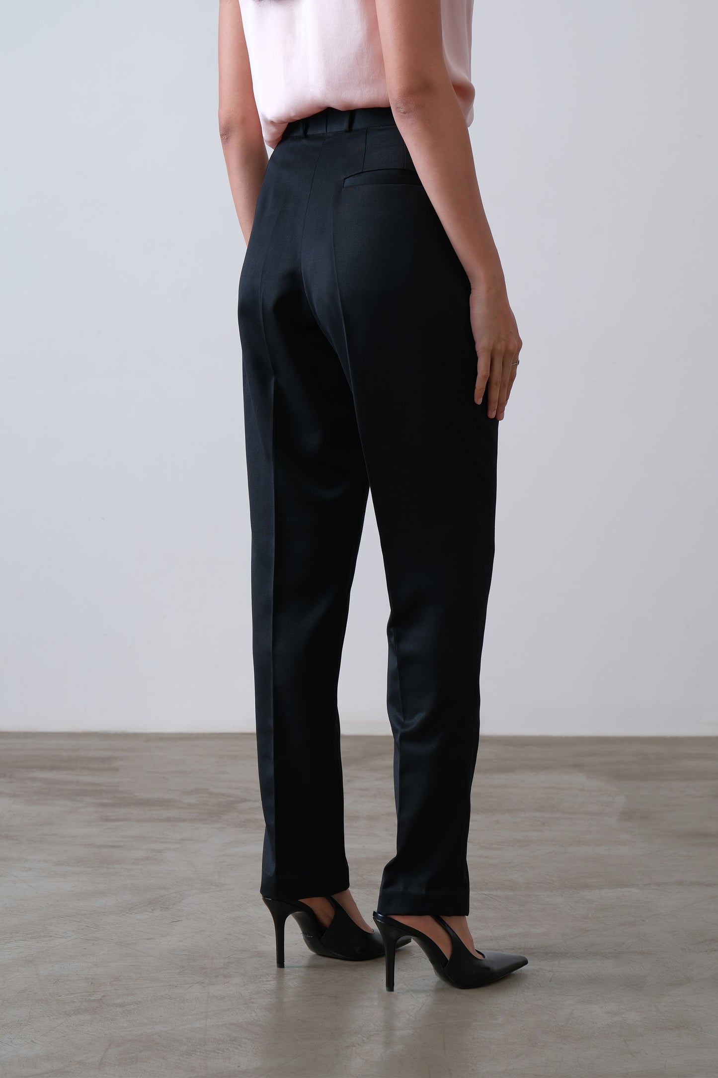 Black poly viscose blend trousers, back view with welt pockets