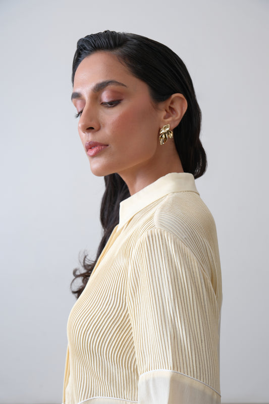 Close up of hand tucks and ivory piping on butter yellow silk crepe shirt