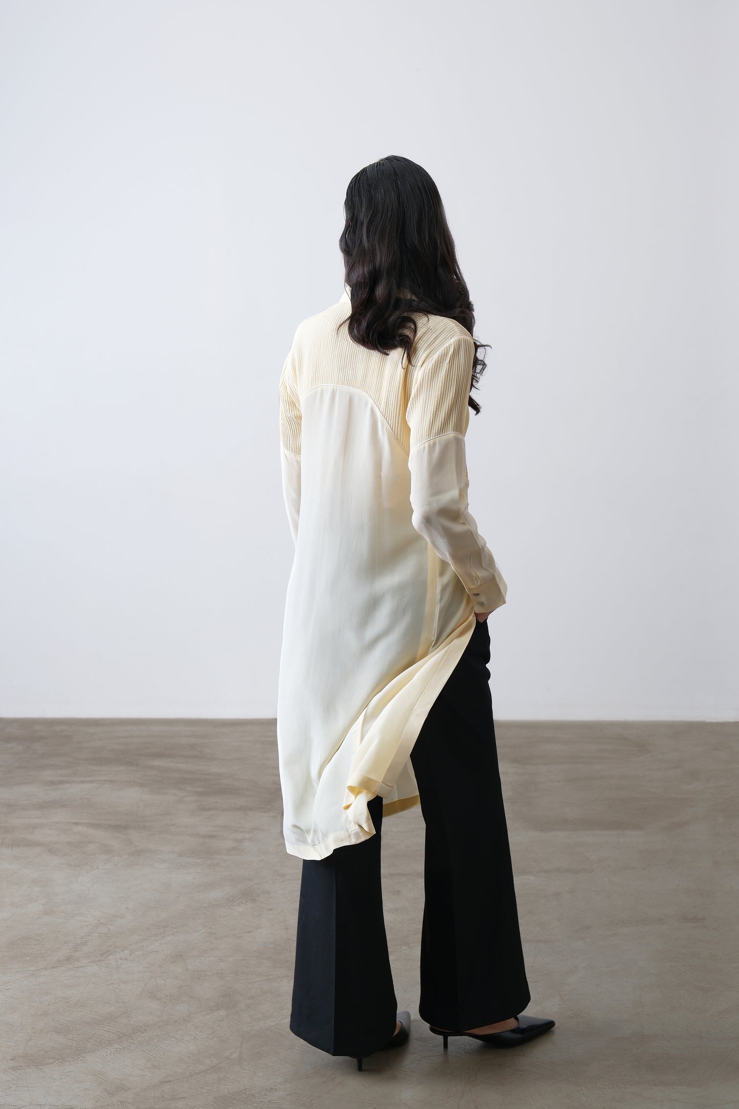 Butter yellow silk crepe shirt, back view with contrast panel and longline cut