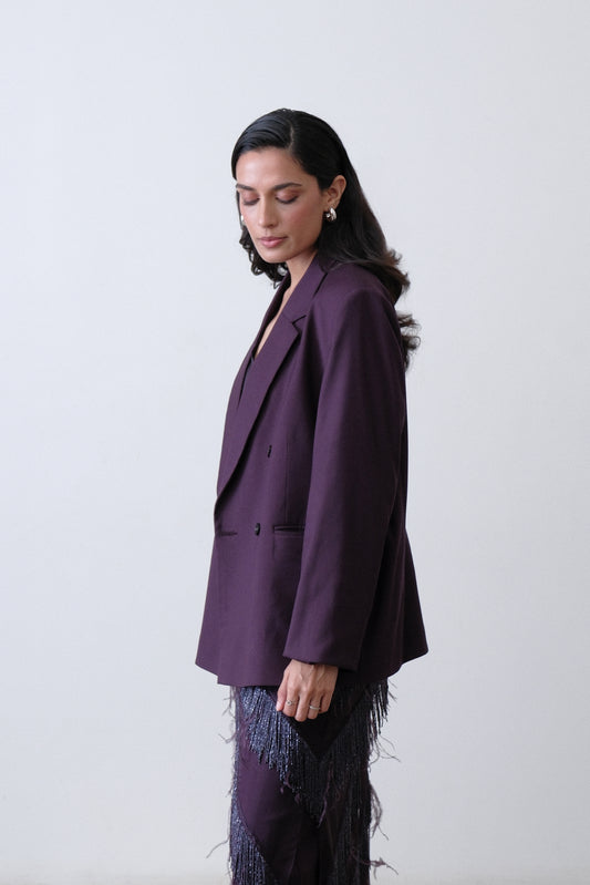 Side view of deep plum double breasted blazer with oversized silhouette