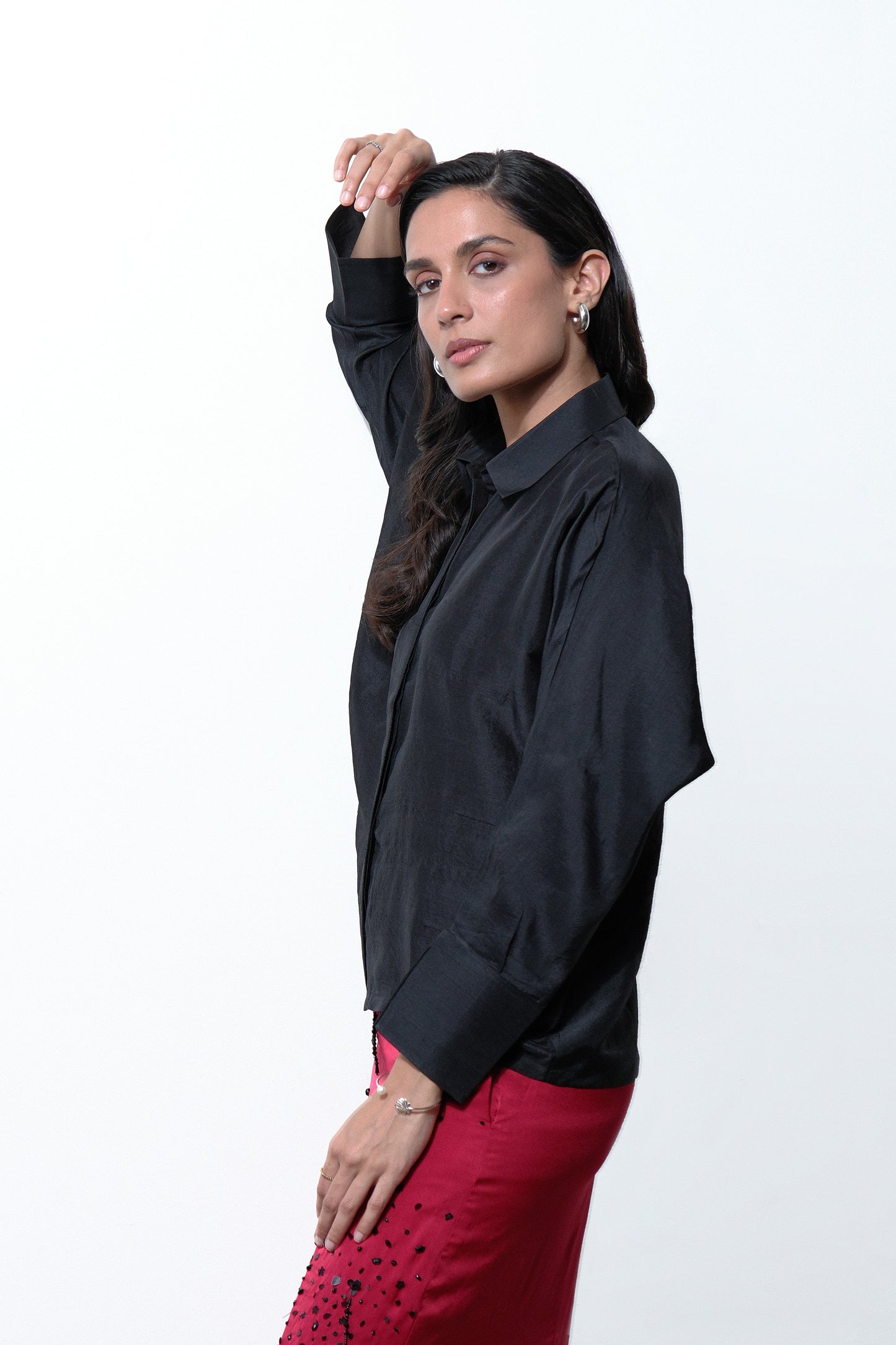 Side view of black dupion silk shirt with turned up satin cuffs