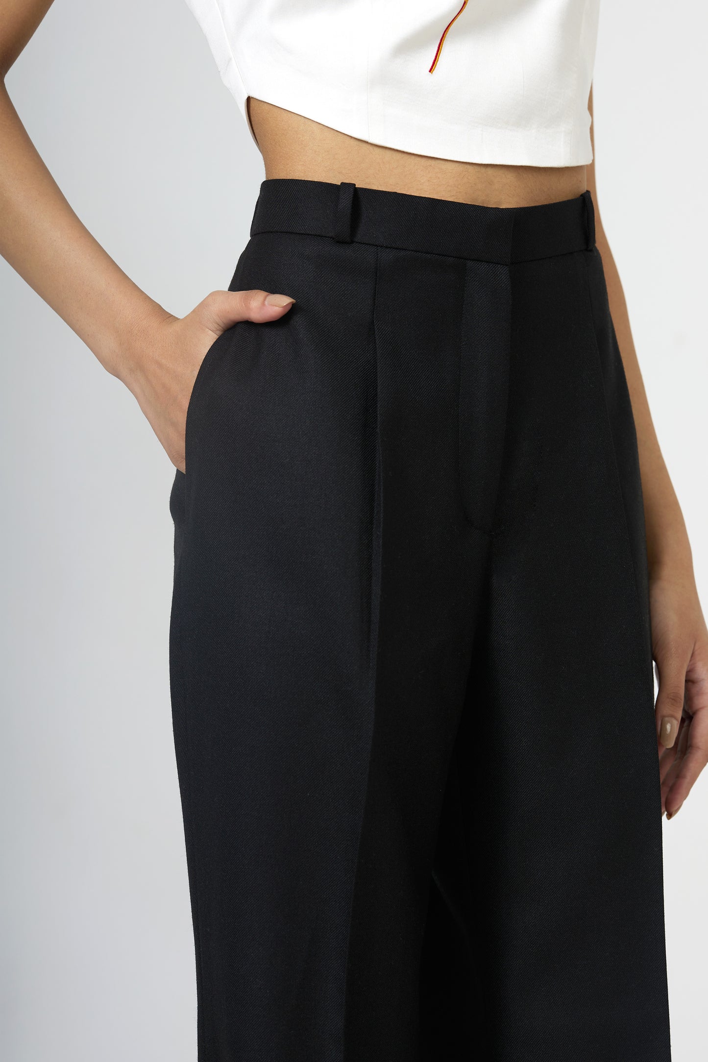black front-pleated flared trousers