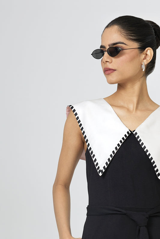 Close up of ivory silk sailor collar with black embroidered check detail