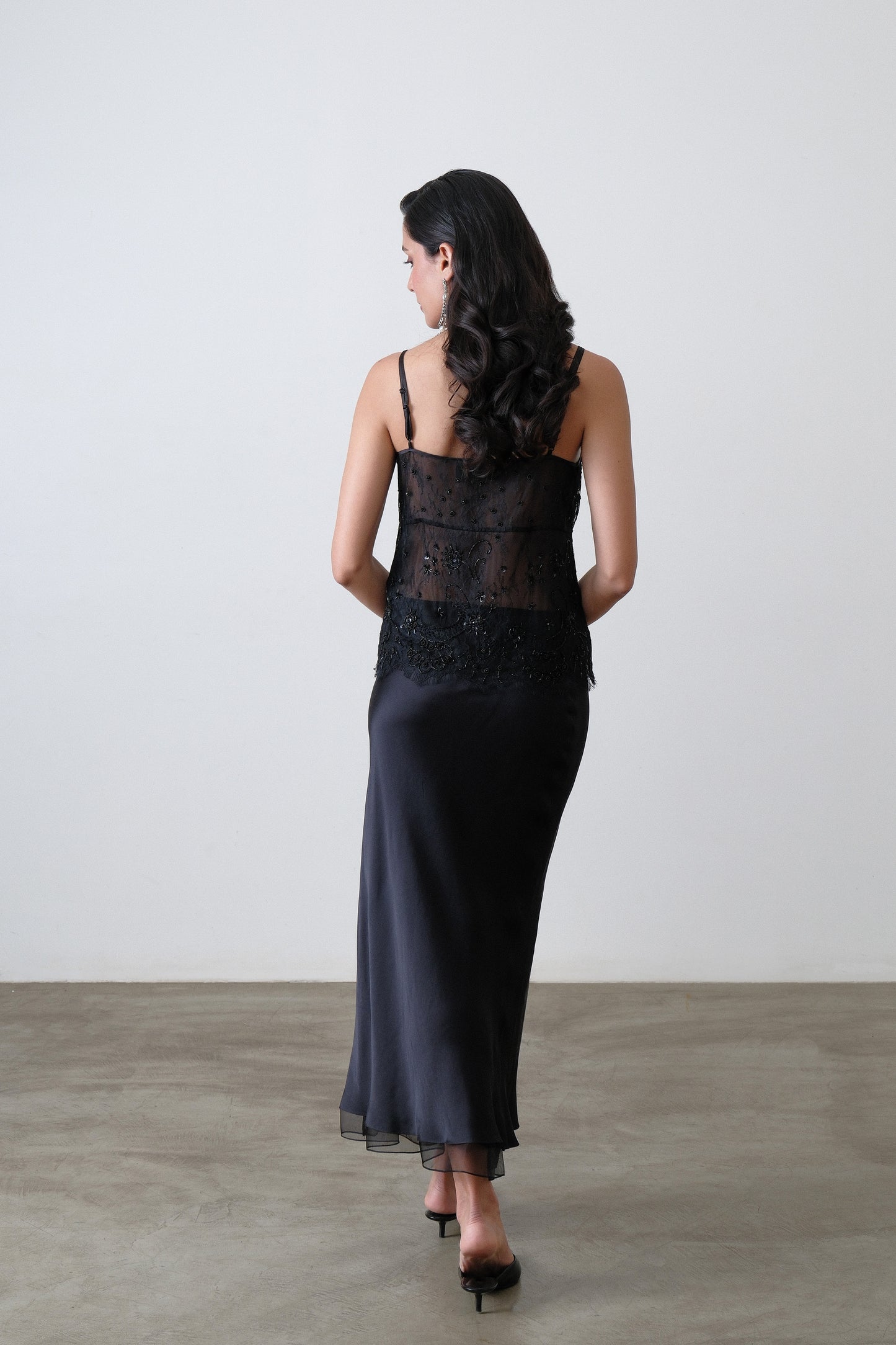 Black silk satin bias skirt, back view with soft drape and organza hem
