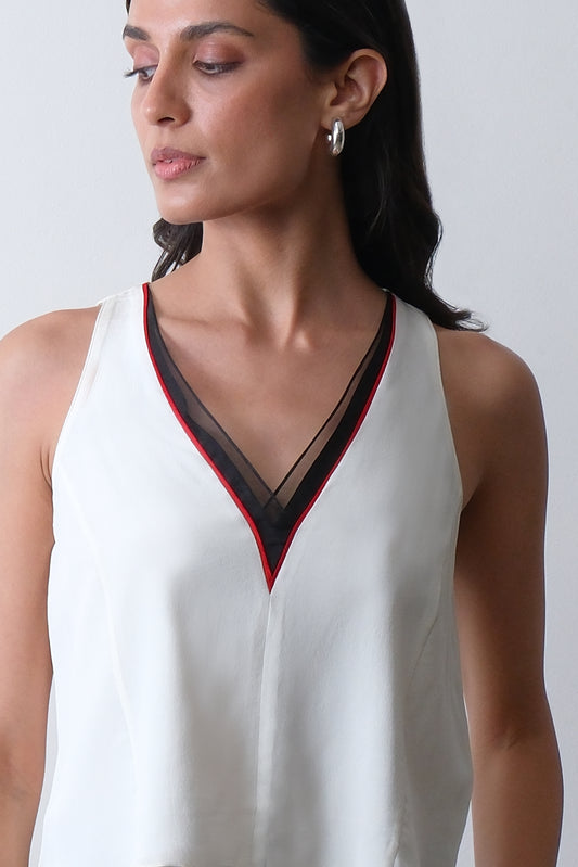 Close up of organza neckline with red piping on ivory silk crepe top