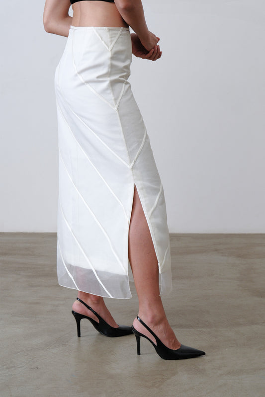 Side view of ivory midi skirt with sheer organza overlay and slit