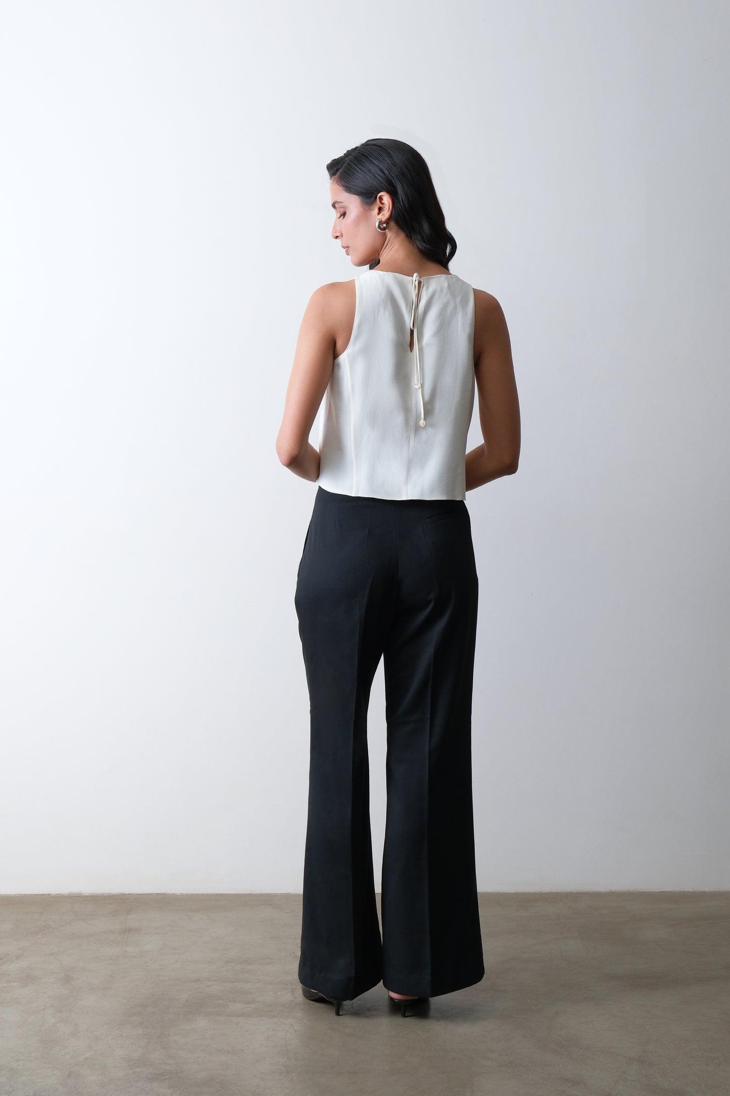 black front-pleated flared trousers