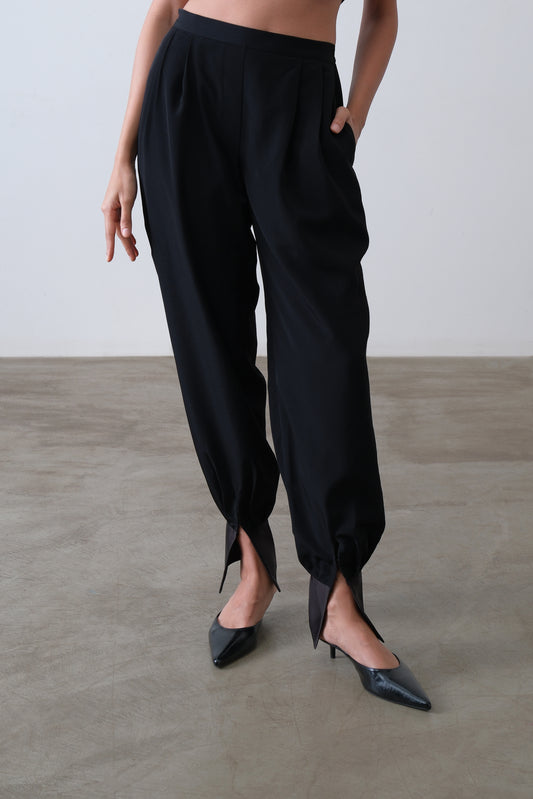 Black viscose blend pleated trousers with tapered leg and satin ankle cuff