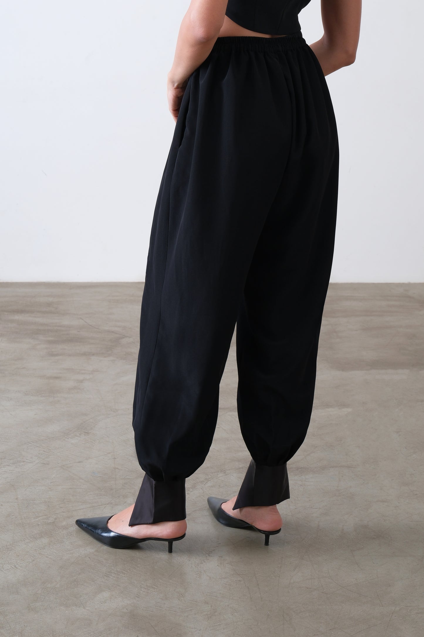 Black viscose blend trousers, back view with elasticated waist and tapered fit