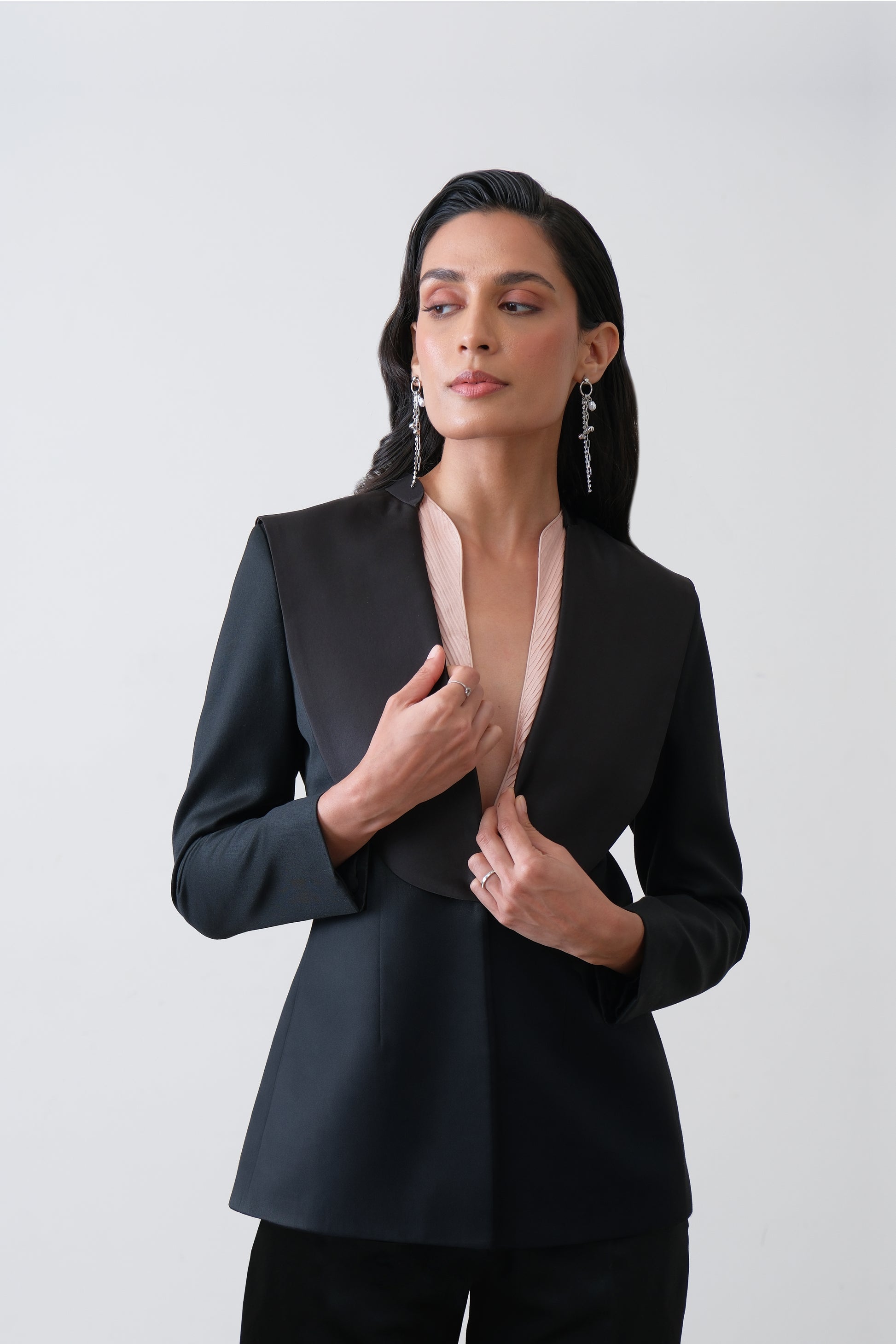 Close up of exaggerated satin collar on black blazer