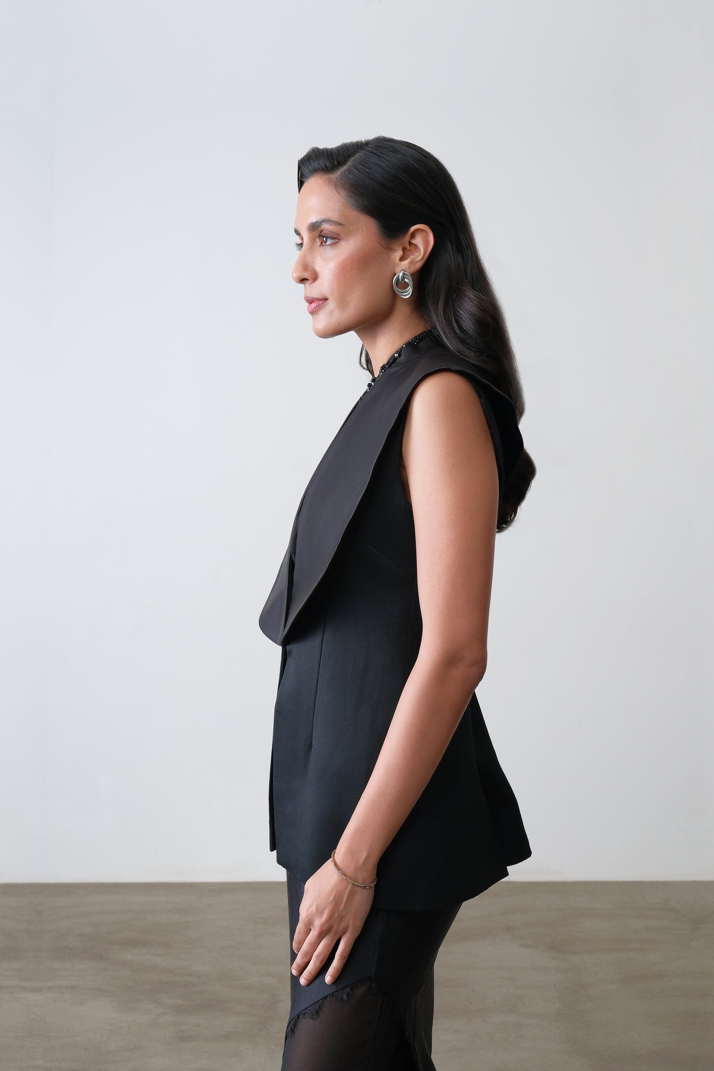 Side view of black waistcoat with exaggerated satin collar