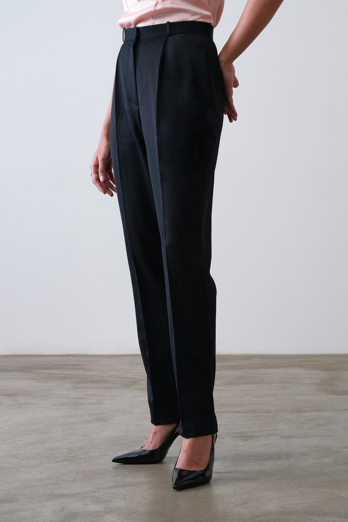 Black poly viscose blend trousers shown at a three quarter angle