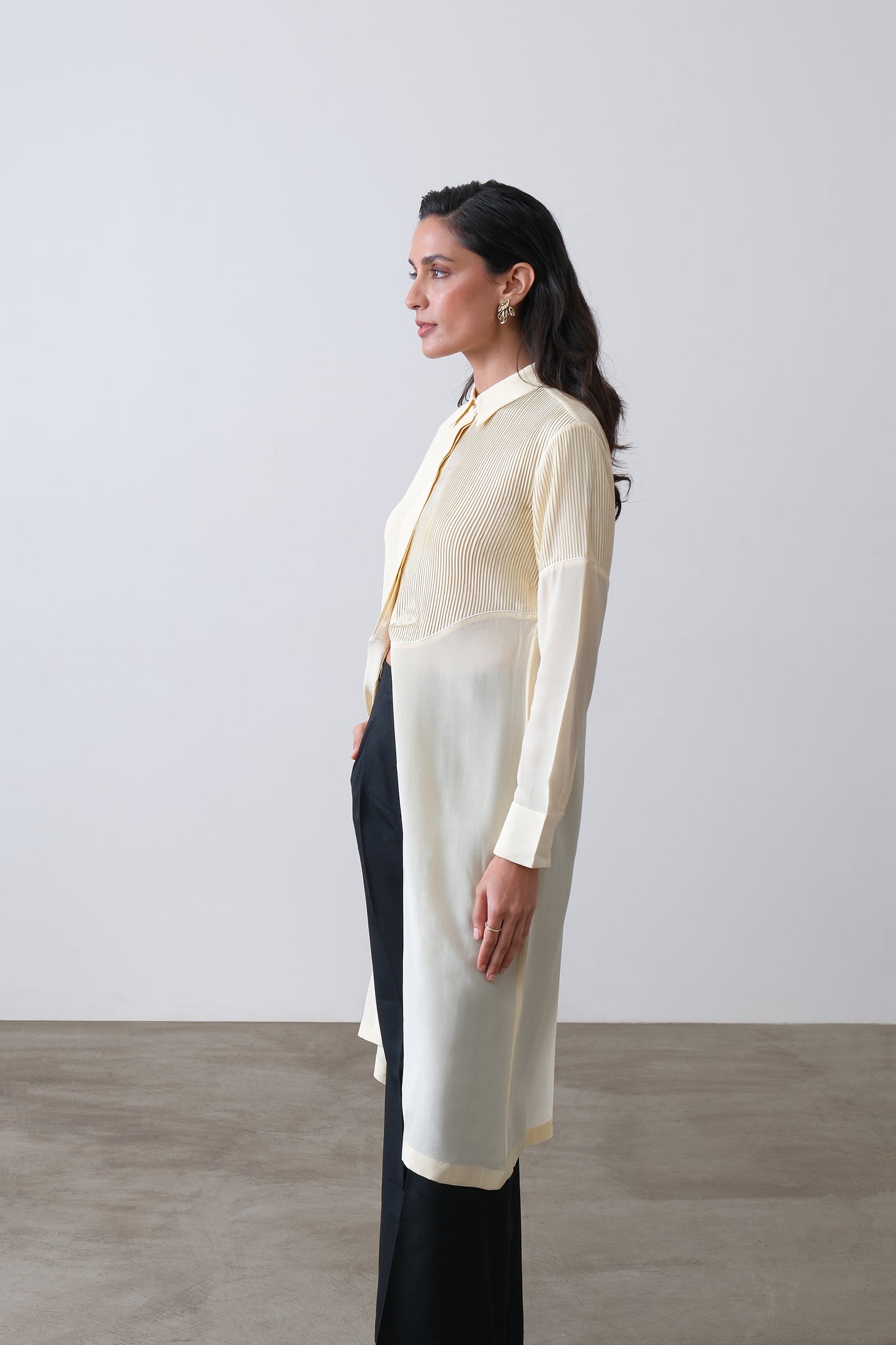 Side view of butter yellow silk crepe shirt with front slit and tailored fit