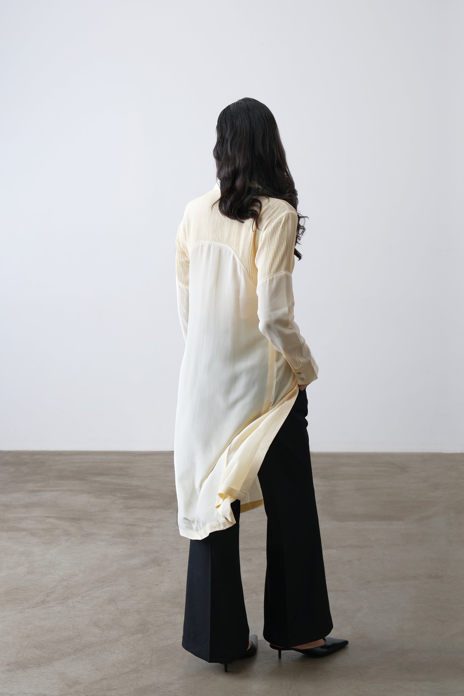 Butter yellow silk crepe shirt, back view with contrast panel and longline cut