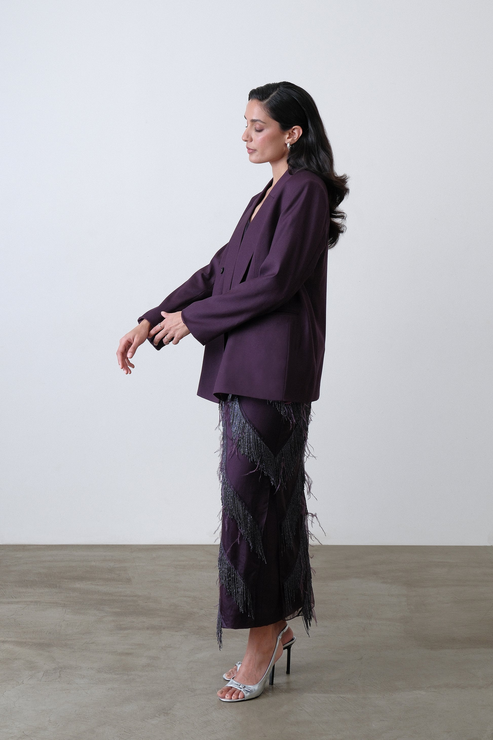 Side view of deep plum double breasted blazer with oversized silhouette
