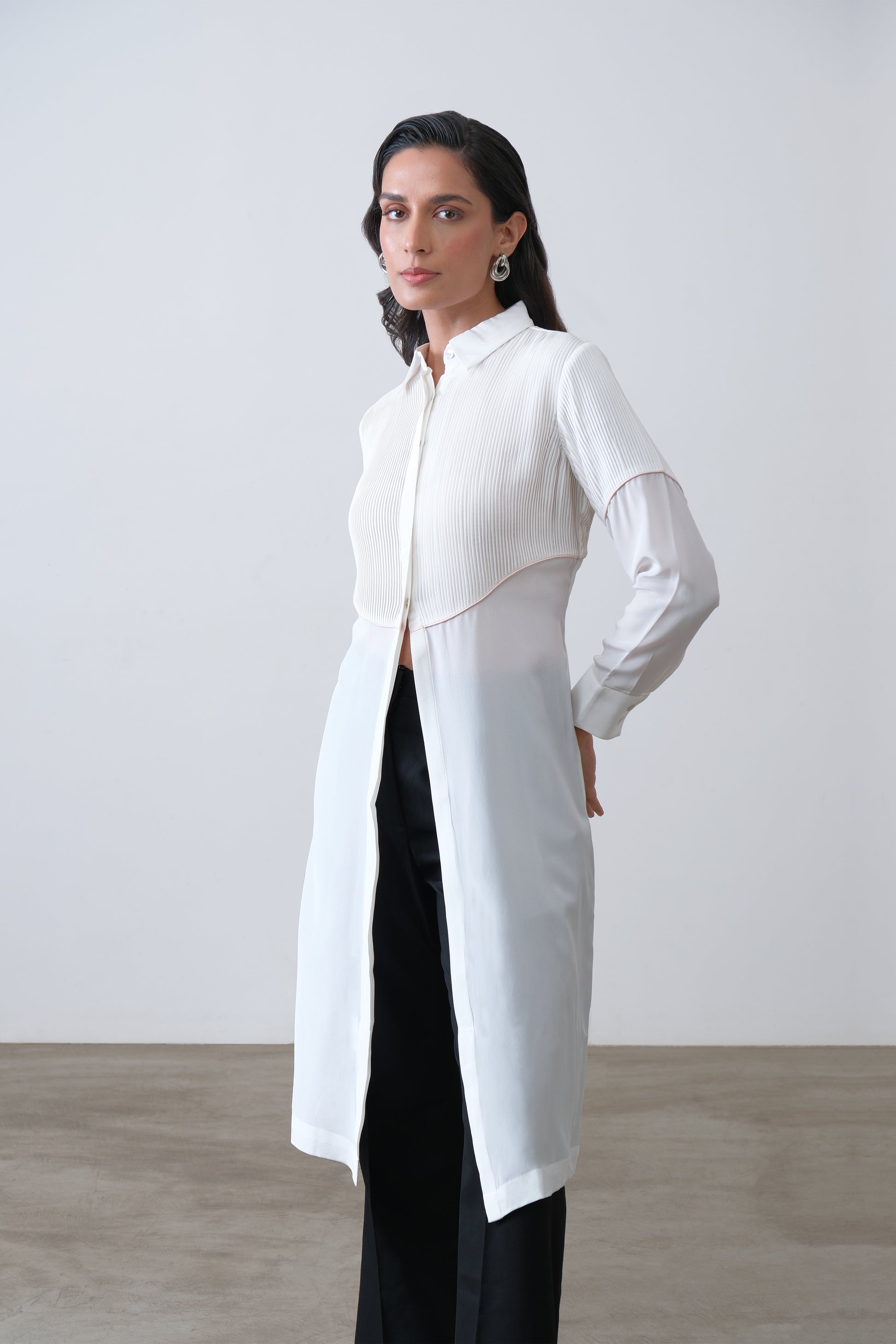 Off white silk crepe longline shirt with hand tucks, pink piping and front slit