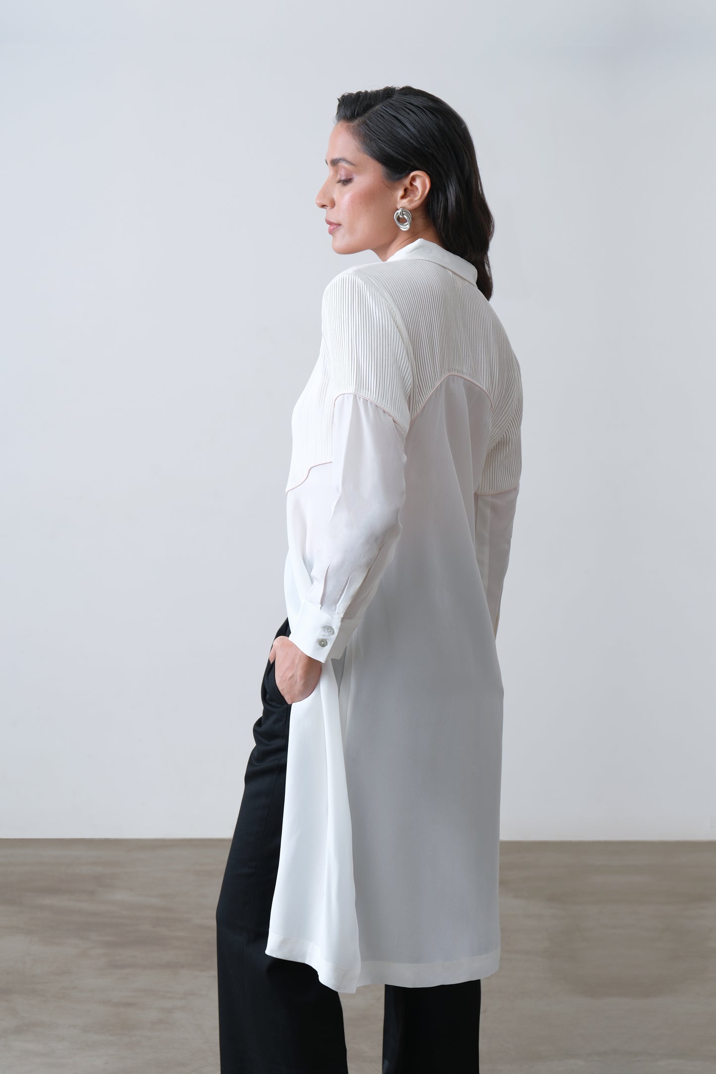 Side view of off white silk crepe shirt with front slit and tailored fit