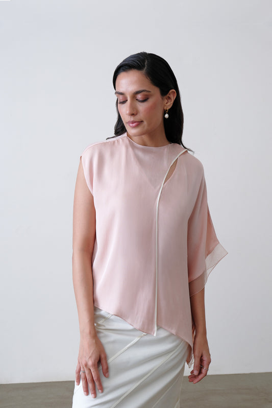 Close up of scarf detail with white piping and organza trim on blush pink silk top