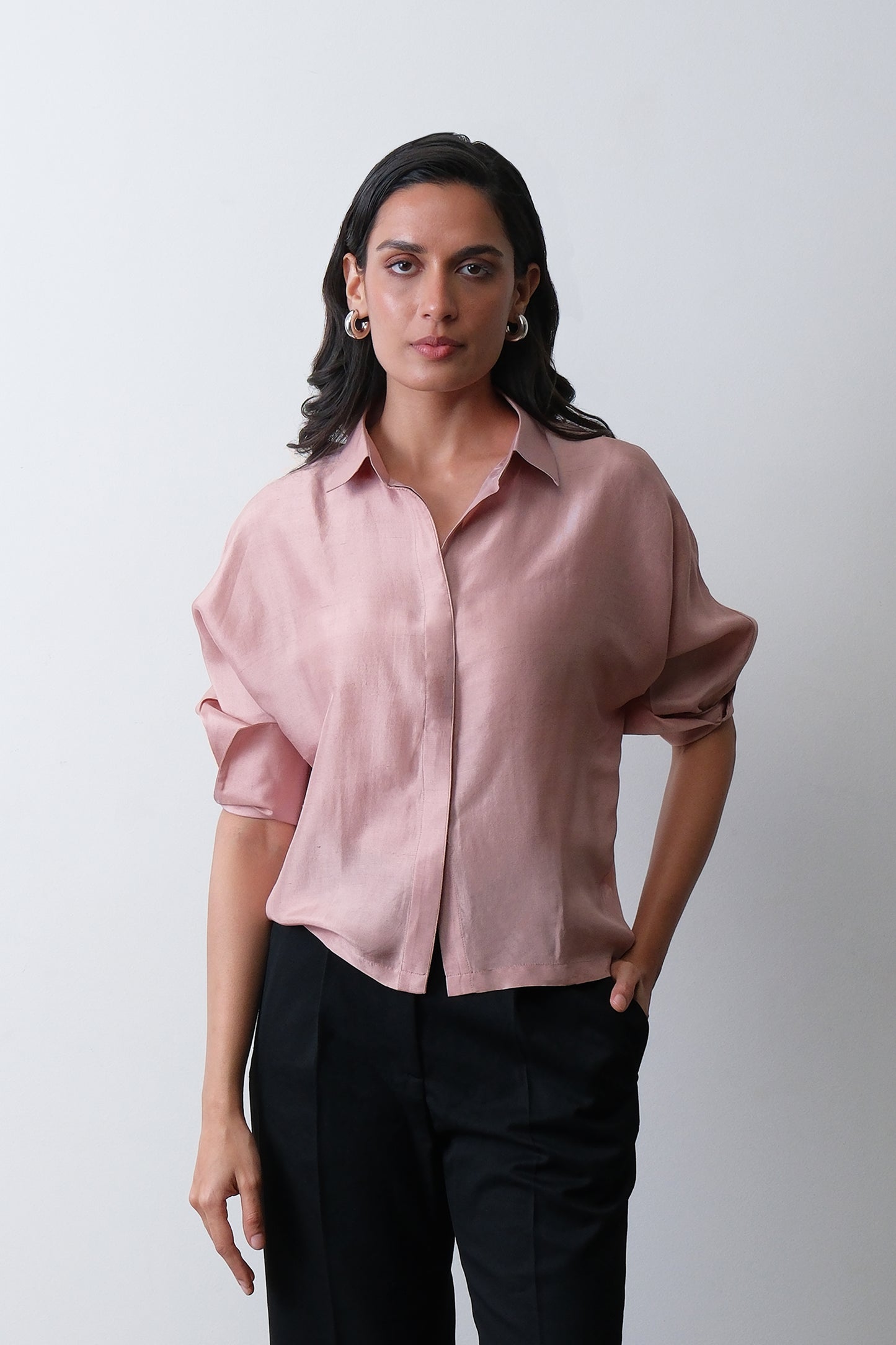 Close up of turned up cuff detail on dusty pink dupion silk shirt