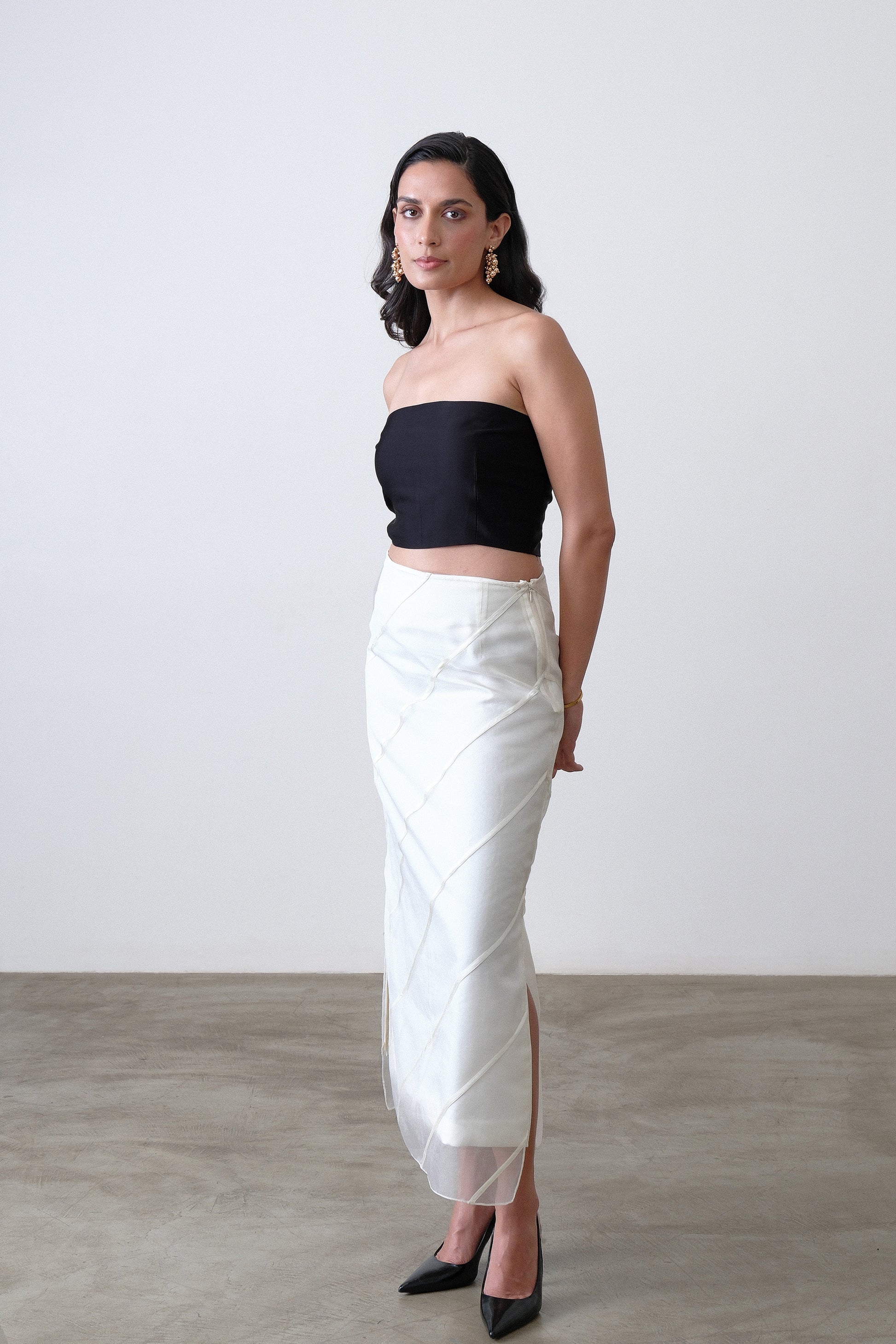 Ivory organza midi skirt shown at a three quarter angle with satin stripes