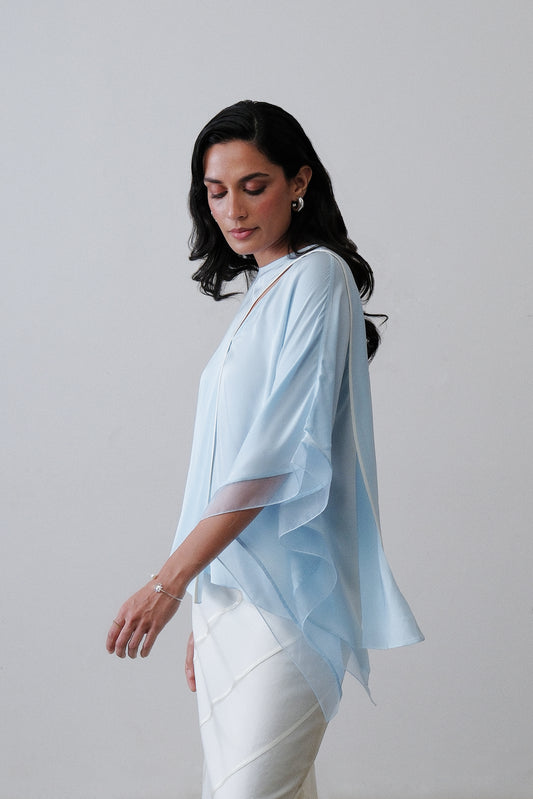 Side view of powder blue silk satin georgette top with kaftan sleeve and organza trim